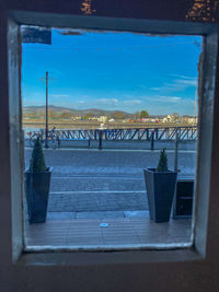 View of glass window against blue sky