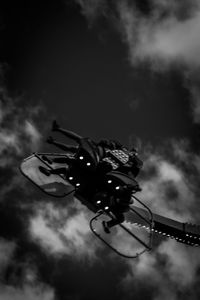 Low angle view of illuminated ferris wheel against sky