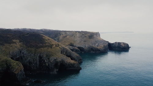 Scenic view of sea and rock formation against sky