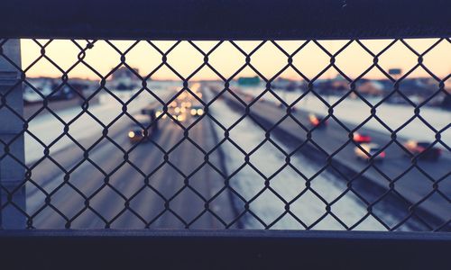 Road seen through chainlink fence