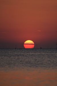 Scenic view of sea against romantic sky at sunset