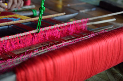 Close-up of red threads on handloom