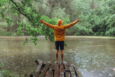 Full length of man standing by lake