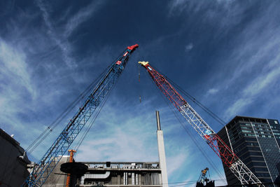 Low angle view of crane against sky at dusk