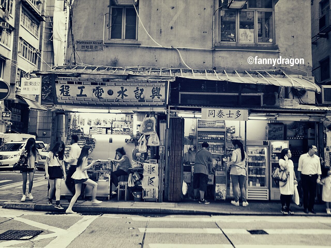 building exterior, architecture, built structure, street, city, men, person, text, city life, large group of people, walking, lifestyles, western script, communication, transportation, building, store, road, city street