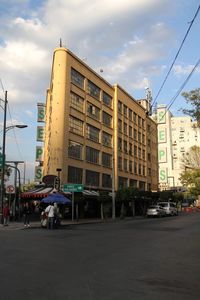 View of city street and buildings against sky