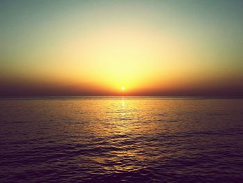 Scenic view of sea against clear sky during sunset