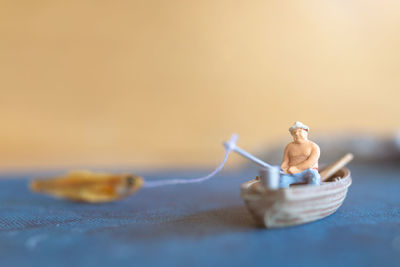 Close-up of figurine in container on table