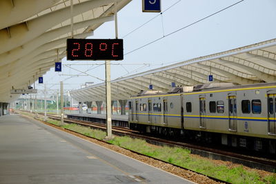 Train at railroad station against sky