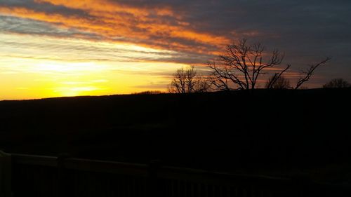 Silhouette landscape against sky during sunset