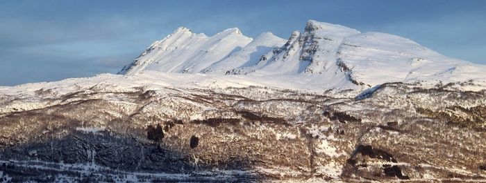 Scenic view of snowcapped mountains against sky