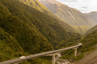 Bridge over mountains against sky