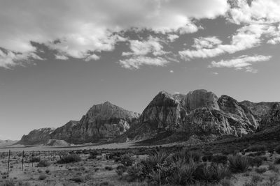 Scenic view of mountains against cloudy sky