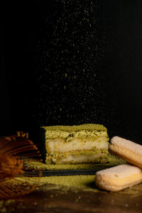 Close-up of food on table against black background