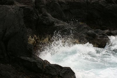 Scenic view of sea against rock formation