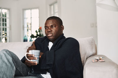 Man sitting on sofa at home