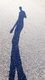 Shadow of man on road