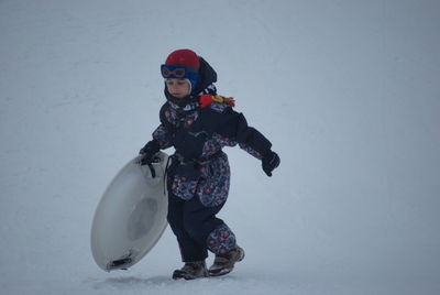 Full length of man standing in snow