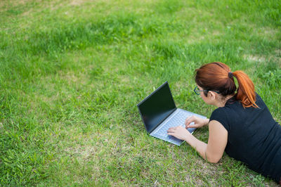 High angle view of man using mobile phone in field