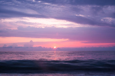 Scenic view of sea against romantic sky at sunset