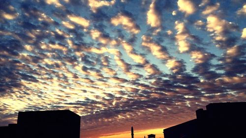 Silhouette of built structure against cloudy sky