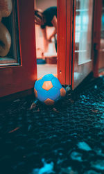 Close-up of soccer ball on window