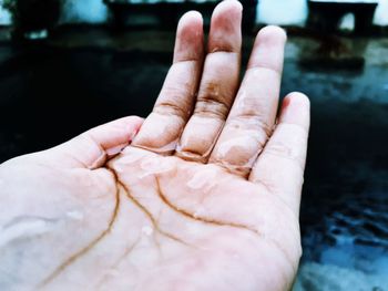 Close-up of person hand holding water