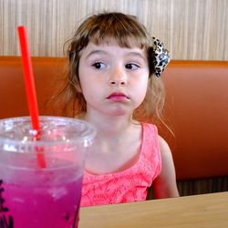 Portrait of a girl sitting on table