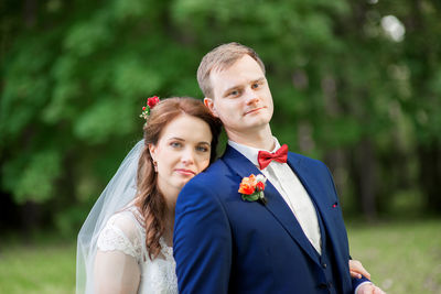 Bride and groom standing at park