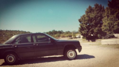 Side view of train on landscape against clear sky