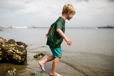 Full length of boy standing on beach