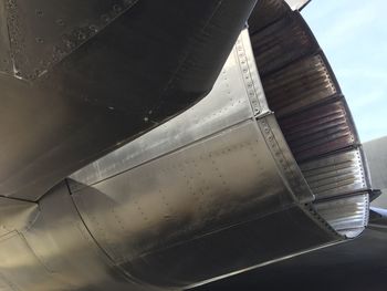 Close-up of airplane wing against sky