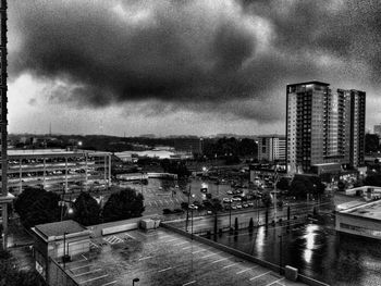 Buildings in city against cloudy sky