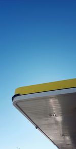 Low angle view of yellow airplane against clear blue sky