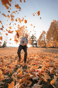 Full length of man standing by tree during autumn