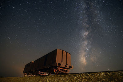 Built structure on field against sky at night