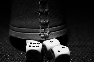 Close-up of dices and leather cup