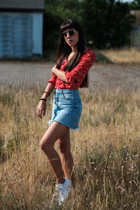 Portrait of beautiful young woman on field