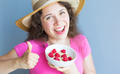 Portrait of smiling woman holding apple