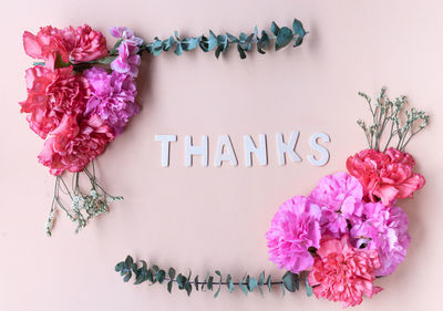 Close-up of pink flowers on table against white background