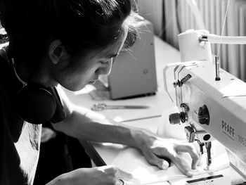 Side view of a long hair man working