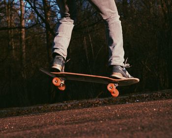 Low section of man jumping outdoors