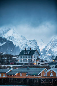 Scenic view of snowcapped mountains against sky in reine norway