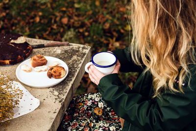 Midsection of woman with coffee