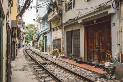 Railroad track by building in city