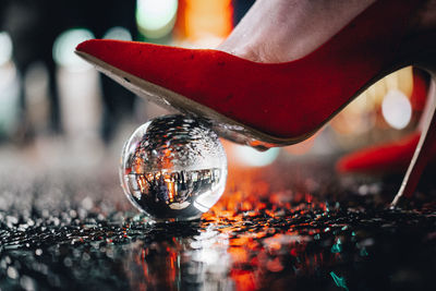 Close-up of red stiletto against blurred background