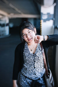 Portrait of beautiful young woman standing at bus