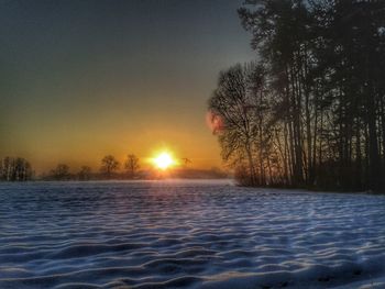 Scenic view of frozen lake against sky during winter