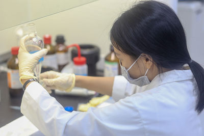 Closeup of an asian woman scientist making an experiment in the laboratory