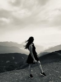 Girl standing on top of a mountain range